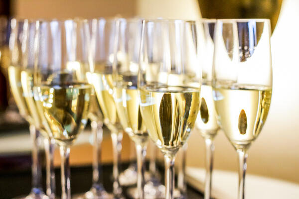 Glasses of champagne and sparkling wine served on a tray at char
