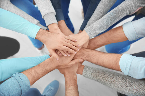 People putting hands together, closeup. Group therapy