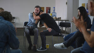 Male addict crying during group meeting