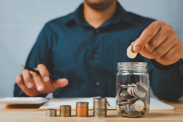 A businessman with a coin in a glass Along with pressing the cal