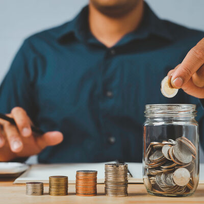 A businessman with a coin in a glass Along with pressing the cal