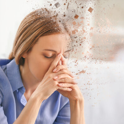 Mature woman suffering from headache at home