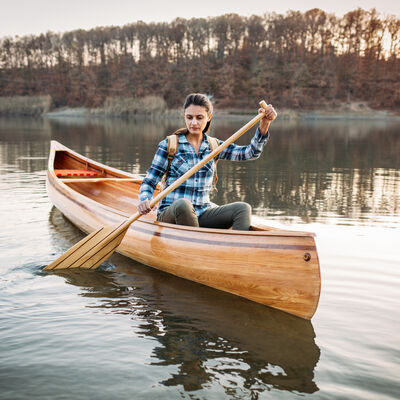 Young woman paddling Indian canoe