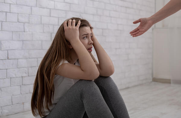 Concept of support for people with emotional problems. Therapist providing psychological help to depressed young woman